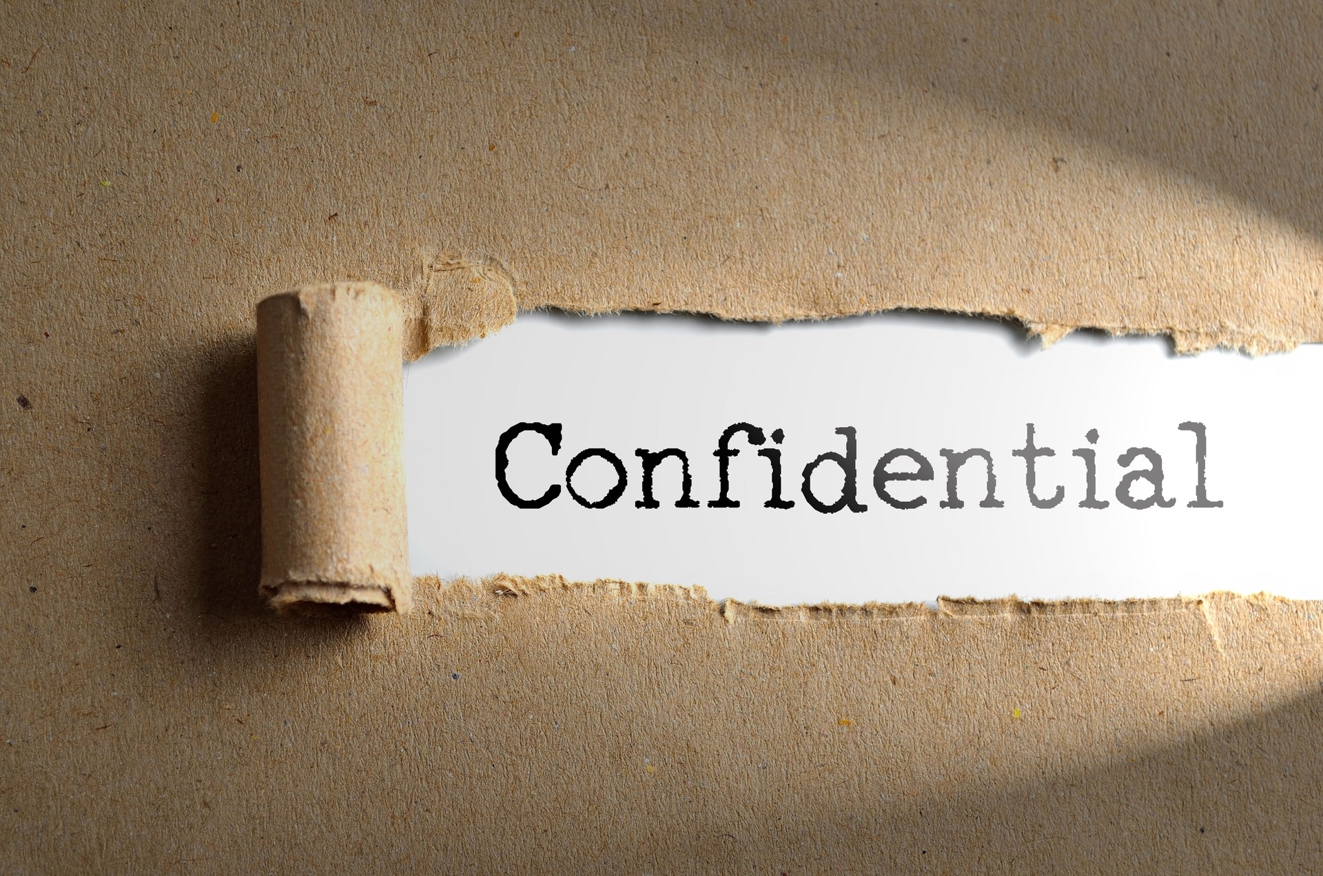 Torn paper with word Confidential